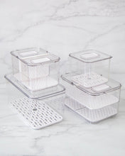 Load image into Gallery viewer, Fridge container set includes four fridge containers that are clear, strong and durable. Features removable dividers for drainage. Can be stacked. Keeps refrigerated food fresher for longer.