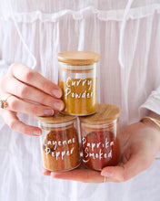 Load image into Gallery viewer, Spice jars and spice rack set. Spice jars featuring bamboo lids with a silicone seal for freshness. Spice rack with three tiers to keep spice jars contained and organised.
