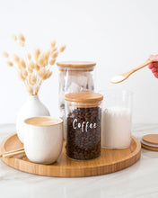 Load image into Gallery viewer, Set of three glass jars with a bamboo lid and silicone seal, featuring one large and two smaller jars
