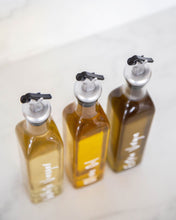 Load image into Gallery viewer, Glass oil bottle with easy to pour pourers to store oils and vinegars and use when cooking