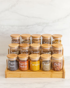 Spice jars and spice rack set. Spice jars featuring bamboo lids with a silicone seal for freshness. Spice rack with three tiers to keep spice jars contained and organised. 