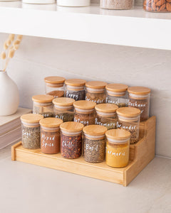 Spice jars and spice rack set. Spice jars featuring bamboo lids with a silicone seal for freshness. Spice rack with three tiers to keep spice jars contained and organised. 
