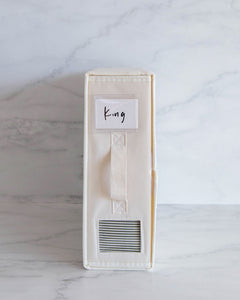 Bed sheet organiser box made from Oxford cloth. Used to differentiate between different sheet sizes. Features a handle and transparent square so you can see what sheets are inside