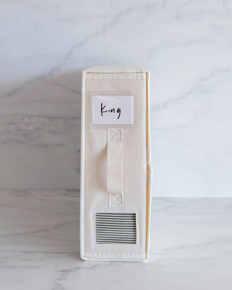 Bed sheet organiser box made from Oxford cloth. Used to differentiate between different sheet sizes. Features a handle and transparent square so you can see what sheets are inside