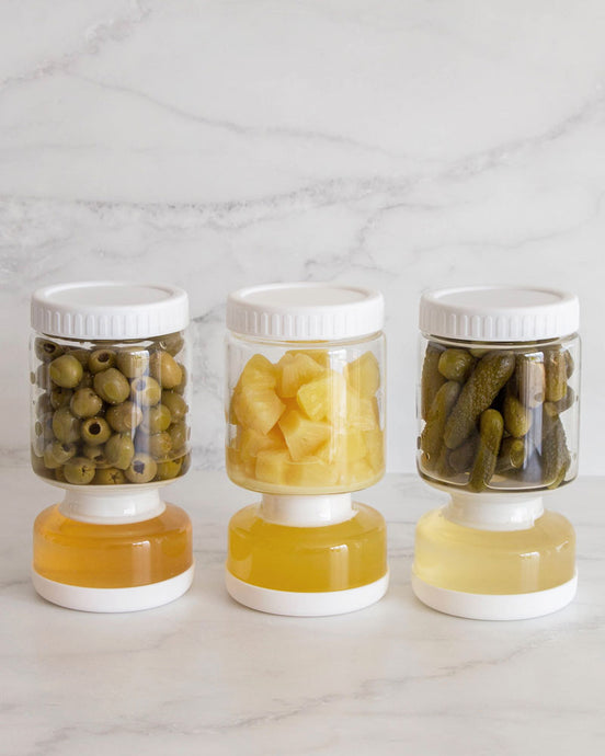 Glass pickle jar in hourglass shape to separate brine from pickles, olives, or other canned goods. Features airtight white silicone lid