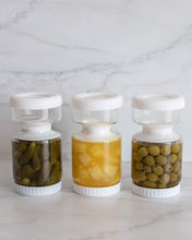 Load image into Gallery viewer, Glass pickle jar in hourglass shape to separate brine from pickles, olives, or other canned goods. Features airtight white silicone lid