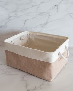 Beige and white storage basket made from linen with a cotton rope handle 