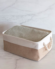 Load image into Gallery viewer, Beige and white storage basket made from linen with a cotton rope handle with sheets inside