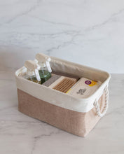 Load image into Gallery viewer, Beige and white storage basket made from linen with a cotton rope handle with cleaning products inside 