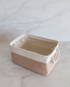 Beige and white storage basket made from linen with a cotton rope handle 