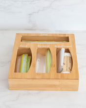 Load image into Gallery viewer, Bamboo sandwich bag organiser with four slots allowing you to hold sandwich bags, rubbish bags, and miscellaneous items in one place