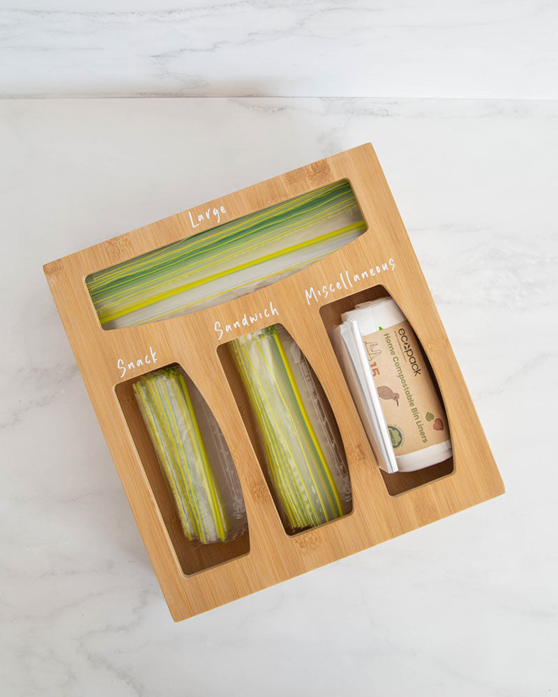 Bamboo sandwich bag organiser with four slots allowing you to hold sandwich bags, rubbish bags, and miscellaneous items in one place