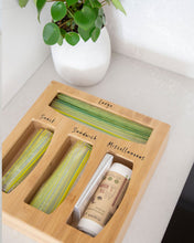 Load image into Gallery viewer, Bamboo sandwich bag organiser with four slots allowing you to hold sandwich bags, rubbish bags, and miscellaneous items in one place