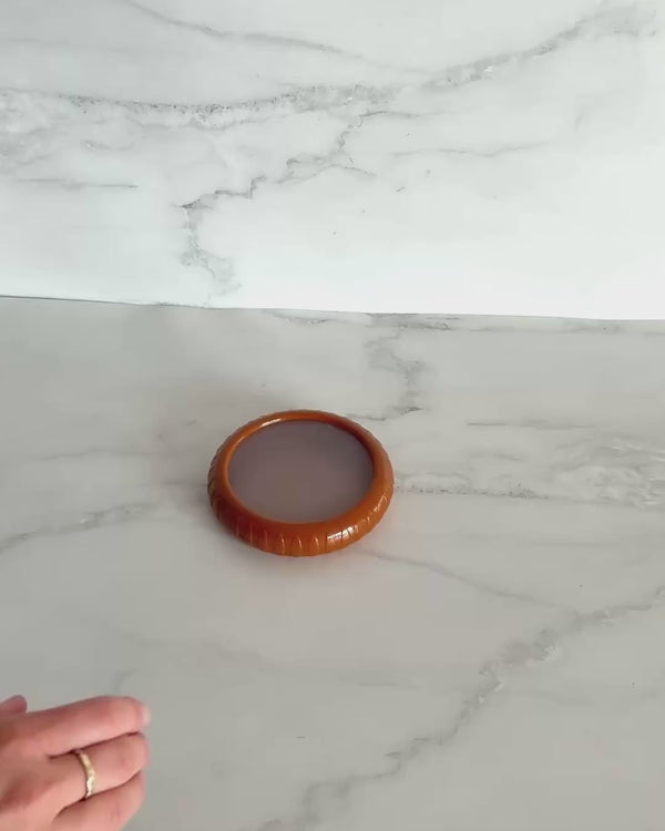 Silicone onion saver pod with flexible lid designed to keep cut onions fresh and prevent drying