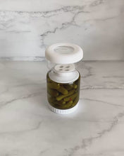 Load image into Gallery viewer, Glass pickle jar in hourglass shape to separate brine from pickles, olives, or other canned goods. Features airtight white silicone lid