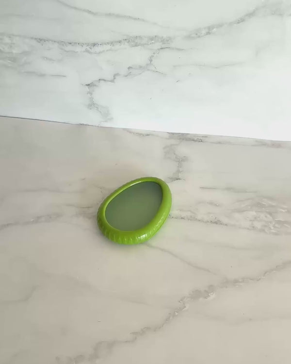 Silicone avocado saver pod with flexible lid designed to keep cut avocados fresh and prevent browning