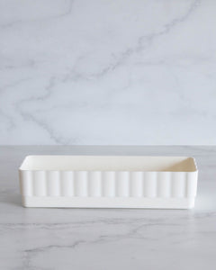 White bathroom container designed to fit in bathroom drawers and store toiletries such as skincare, makeup, haircare and perfumes