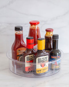 Transparent Lazy Susan that is 30cm diameter, used to store sauces and bottles in the fridge or pantry
