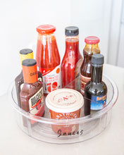 Load image into Gallery viewer, Transparent Lazy Susan that is 30cm diameter, used to store sauces and bottles in the fridge or pantry