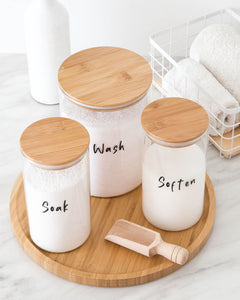 Laundry set with glass jars and bamboo lid used to store laundry items such as washing powder