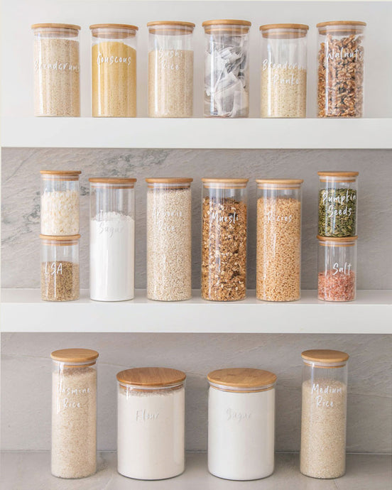 Pantry glass jars with bamboo lid and silicone seal used to store essential household pantry ingredients such as flour, sugar and spaghetti 
