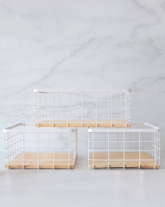 White wire basket with wooden base for organising and storing items in the kitchen, pantry and bedroom