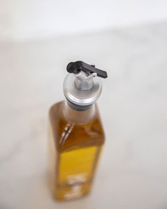 Glass oil bottle with easy to pour pourers to store oils and vinegars and use when cooking