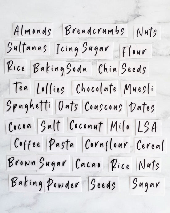 Vinyl labels with common household pantry ingredients that peel back and stick onto kitchen jars such as flour, sugar, spaghetti and more