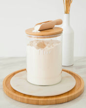 Load image into Gallery viewer, Wooden scoop with handle used to scoop ingredients such as flour and sugar from a jar