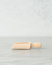 Load image into Gallery viewer, Wooden scoop with handle used to scoop ingredients such as flour and sugar from a jar